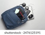 Laptop with Modern gadgets and accessories for work and study in Backpack on white background.