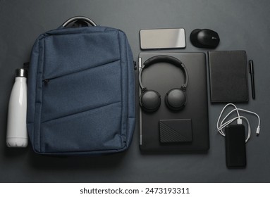 Laptop with Modern gadgets and accessories for work and study with Backpack on dark gray background. Top view. Flat lay - Powered by Shutterstock