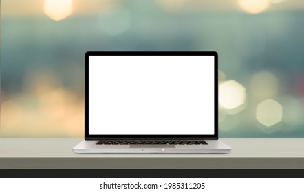 Laptop or notebook with blank screen on wood table in blurry background 