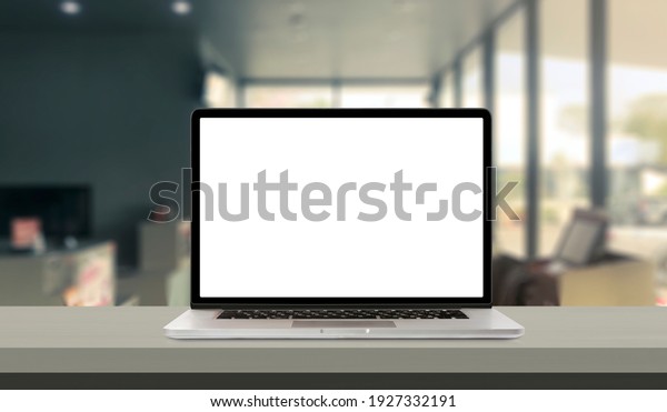 Laptop or notebook with blank screen on service\
counter in blurry background with parcel delivery office express,\
EMS.