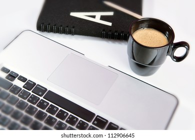 Laptop (notebook) with cup of coffee and notepad
