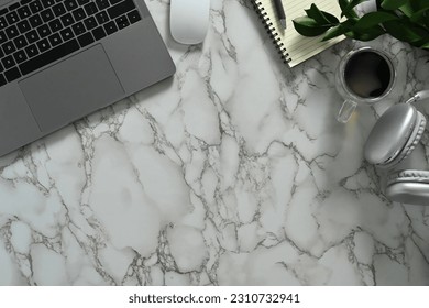 Laptop, notepad, headphone, notepad and coffee cup on marble table. Top view with copy space - Shutterstock ID 2310732941