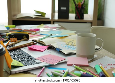 Laptop, Notes And Office Stationery In Mess On Desk. Overwhelmed With Work