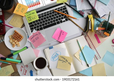 Laptop, Notes And Office Stationery In Mess On Desk, Top View. Overwhelmed With Work