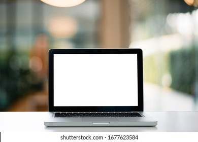Laptop on Computer Desk and Laptop with blank screen for product display in office with modern blurred background.- Image