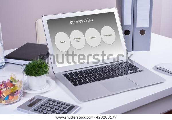 Laptop On Desk Business Plan On Stock Photo Edit Now 423203179