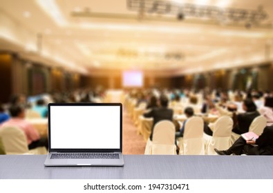 Laptop On Desk In Seminar Room With Staff