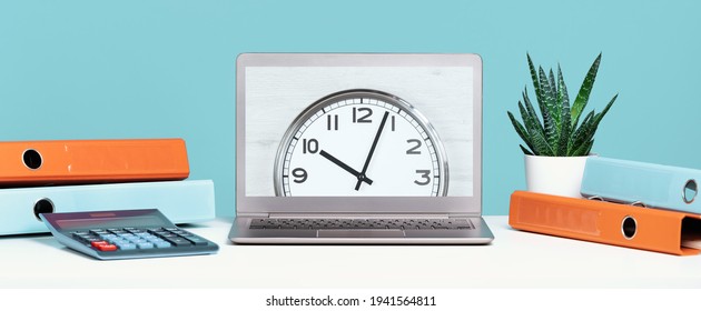 Laptop On Office Desk With Clock In The Center And Folders, Calculator. Ten O'clock. Banner With Copy Space, Time Management Or Schedule Agenda Concept And Lunch Time. Opening Or Closing Hours.