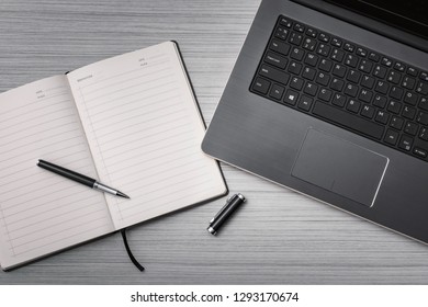 laptop on the table with notebook and pen, working concept