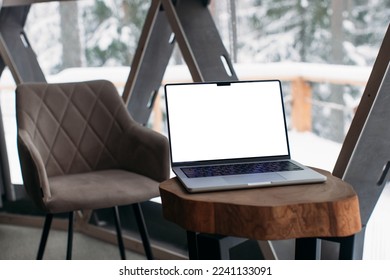 laptop on the table with space for a signature. Macbook 14 pro 2021. winter outside the window. copy space

