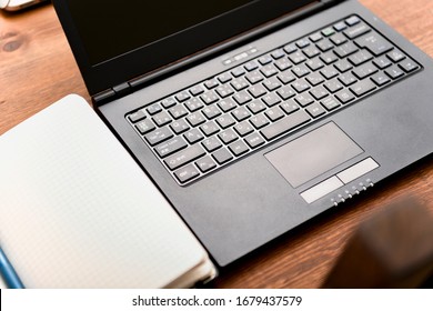 Laptop on wooden desk, taken in studio - Shutterstock ID 1679437579