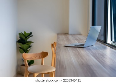 A Laptop On A Working Desk By The Window. Shallow Depth Of Field.