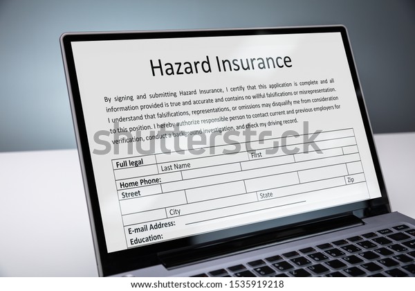 Laptop With\
Online Hazard Insurance Form On\
Desk