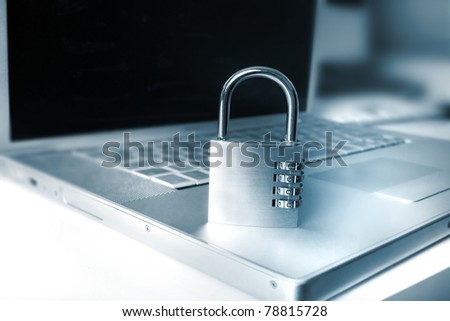 laptop and padlock as a metaphor for secure systems and computing