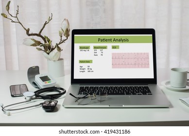 Laptop With Patient Analysis On Doctor's Desk