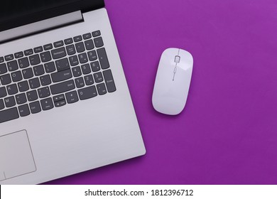 Laptop With Pc Mouse On Purple Paper Background. Online Workspace. Remote Work. Studio Shot. Top View. Flat Lay