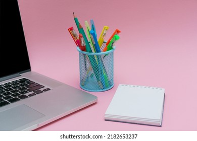 Laptop Pens And Colored Pencils In Blue Stand And White Stickers On Pink Background, Back To School And Business Education Concept