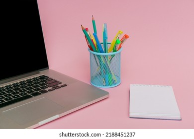 Laptop Pens And Colored Pencils In Blue Stand And White Stickers On Pink Background, Back To School And Business Education Concept