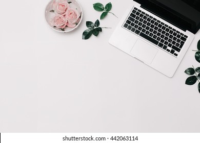 Laptop With Pink Roses On White Background. Flat Lay