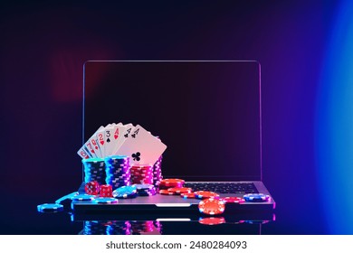 Laptop With Playing Cards and Poker Chips on a Green Table - Powered by Shutterstock