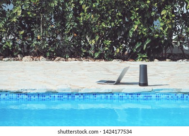 Laptop And Portable Speaker Near The Swimming Pool. Hotel In The Caribbean.