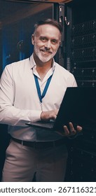 Laptop, portrait and database with man in server room for data center, network or systems. Cybersecurity, software technician and cloud computing with mature person for hardware maintenance and code