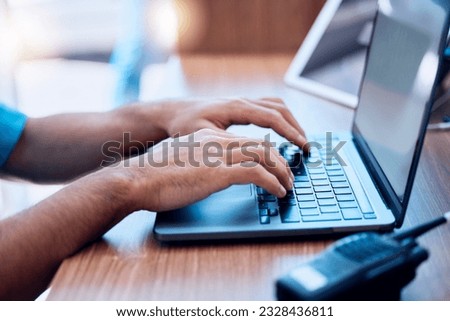 Laptop, radio and hands of security typing or writing an investigation project at a law enforcement office. Police, keyboard and person or officer working on internet crime and criminal email online