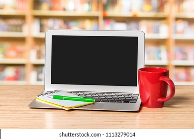 Laptop With Red Mug On Wooden Table