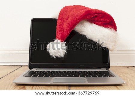 laptop and santa claus cap