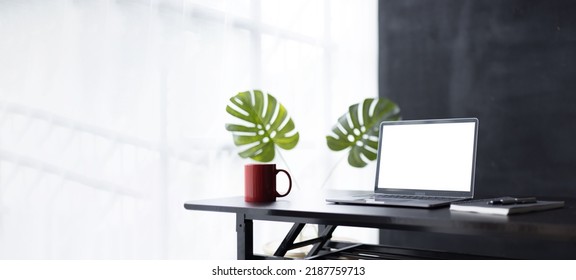 Laptop Screen, Laptop Computer, Notebook Copy Space, And Eyeglasses Sitting On A Desk In A Large Open Plan Office Space After Working Hours