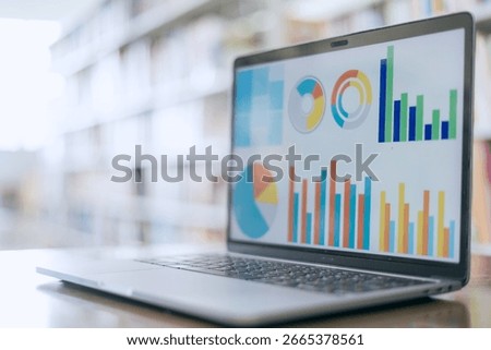 Laptop screen displaying graphs representing business concepts.