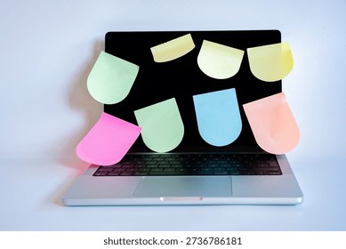 Laptop screen displaying a multitude of blank, colorful sticky notes, symbolizing digital organization, reminders, and daily workflow