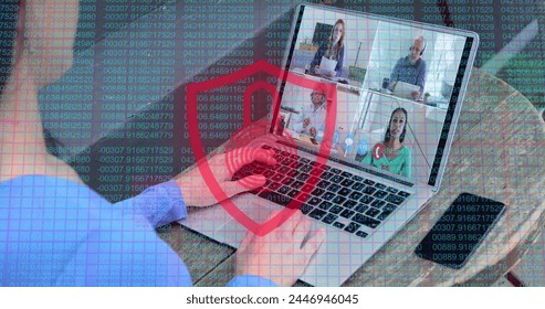 Laptop screen displays a virtual meeting with four participants. Overlay of digital security elements suggests a focus on cybersecurity in remote work environments. - Powered by Shutterstock