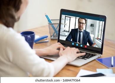 Laptop screen view confident male boss leader holding videoconference business negotiations with female partner worker employee due to coronavirus covid19 world outbreak quarantine, remote online job.