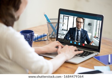 Laptop screen view confident male boss leader holding videoconference business negotiations with female partner worker employee due to coronavirus covid19 world outbreak quarantine, remote online job.