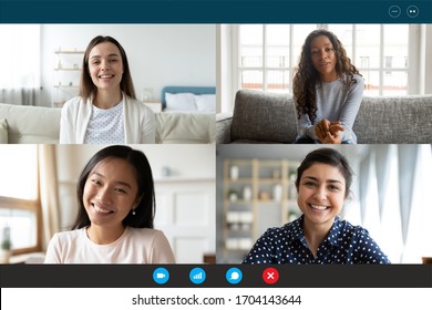 Laptop screen webcam view four multi ethnic beautiful millennial women involved in group video call. Meeting of friends on-line, colleagues working distantly, virtual communication modern tech concept