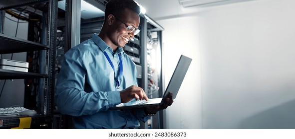 Laptop, server room and black man on network for maintenance, programming software or typing. Tech, data center and happy engineer on system database for information, cybersecurity or cloud computing - Powered by Shutterstock