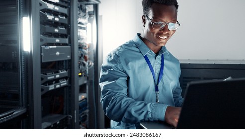 Laptop, server room and technician programming software, update or system network maintenance. Technology, data center or happy black man on database for information, cybersecurity or cloud computing