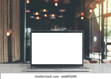 laptop showing blank screen in coffee shop restaurant - Shutterstock ID 666892090