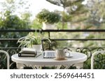 Laptop side view and coffee cup with notebooks on white table balcony outdoor