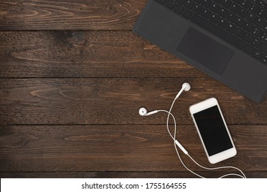 Laptop And Smartphone On The Desk. Top View Shot, Working At Home Concept