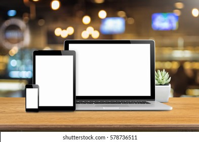 Laptop Smartphone And Tablet Mockup On Desk With Blurred Background.