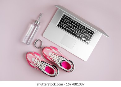 Laptop, Sneakers And Water Bottle On A Pink Background. Online Fitness Program. Home  Workout. Top View, Flat Lay