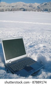 Laptop in a snowy winter landscape scene