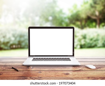 Laptop stands on a wooden table outdoors - Powered by Shutterstock