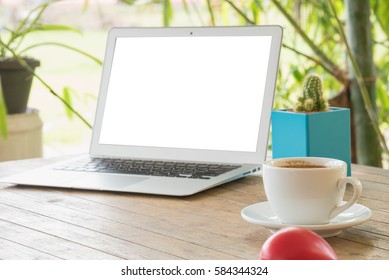 Laptop Stands On A Wooden Table Outdoors