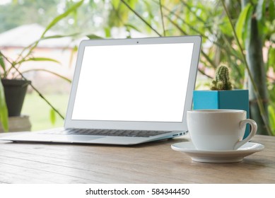 Laptop Stands On A Wooden Table Outdoors