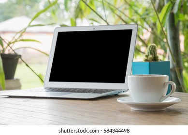 Laptop Stands On A Wooden Table Outdoors