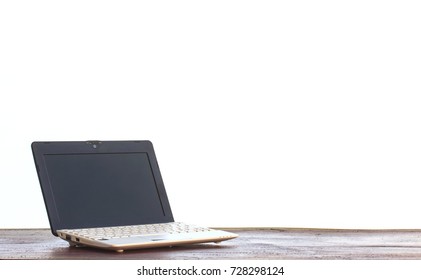 Laptop Stands On A Wooden Table On White Background