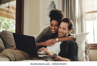 Laptop, streaming and an interracial couple watching a movie using an online subscription service for entertainment. Computer, relax or internet with a man and woman bonding together over a video - Powered by Shutterstock